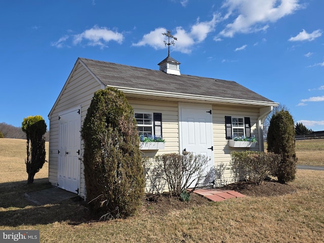 view of front of home with roof with shingles and a front lawn