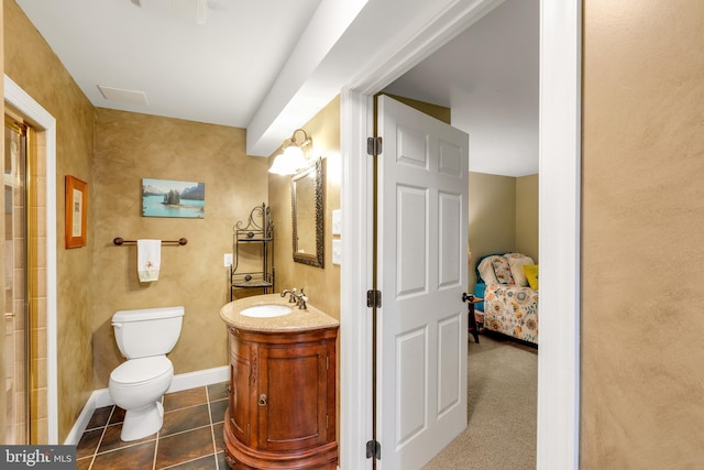 bathroom featuring tile patterned flooring, toilet, vanity, and baseboards