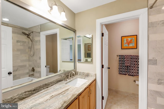 full bath featuring shower / bath combination, toilet, vanity, and baseboards