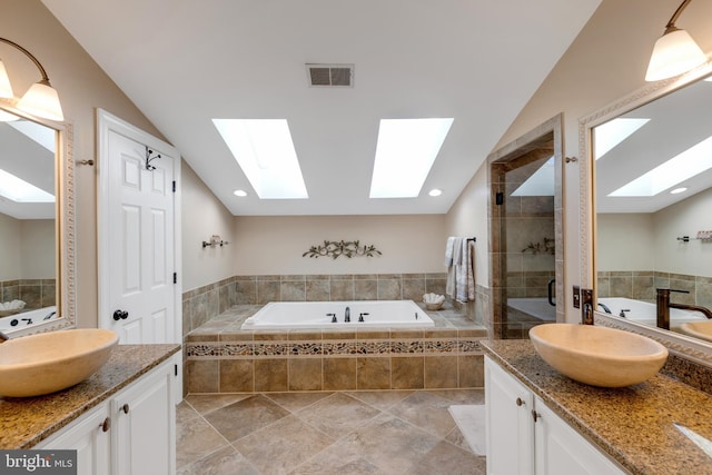 full bath featuring vanity, lofted ceiling, visible vents, and a stall shower