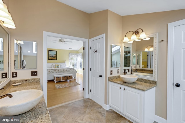 full bathroom featuring tile patterned flooring, two vanities, a ceiling fan, and a sink