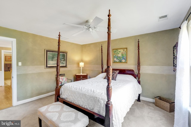 carpeted bedroom featuring visible vents, baseboards, and ceiling fan