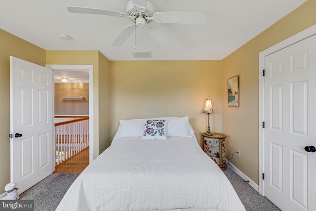 bedroom featuring visible vents, baseboards, carpet, and a ceiling fan