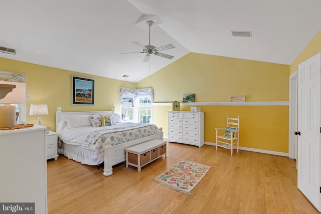 bedroom with a ceiling fan, wood finished floors, visible vents, baseboards, and lofted ceiling