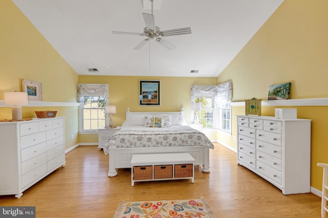 bedroom with lofted ceiling, visible vents, and light wood-type flooring