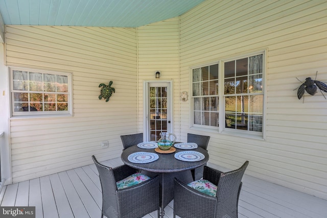 wooden deck featuring outdoor dining area