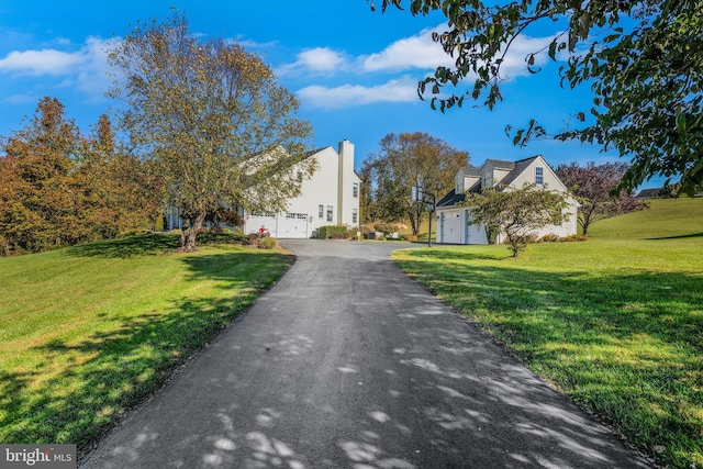 view of front of property with a front lawn and a garage