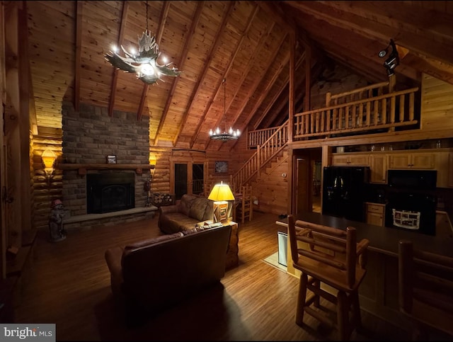 1608 Woodyard Rd, Grafton, WV 26354 - living room with an inviting chandelier, a stone fireplace, high vaulted ceiling, stairway, and light wood-style flooring
