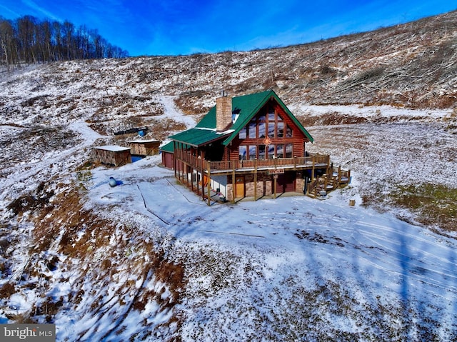 1608 Woodyard Rd, Grafton, WV 26354 - snow covered property featuring a chimney, stairs, and a wooden deck