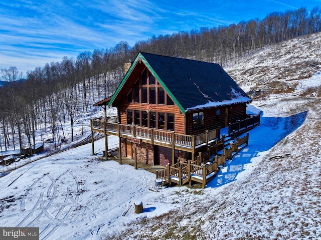 1608 Woodyard Rd, Grafton, WV 26354 - snow covered rear of property featuring a deck, a chimney, and stone siding