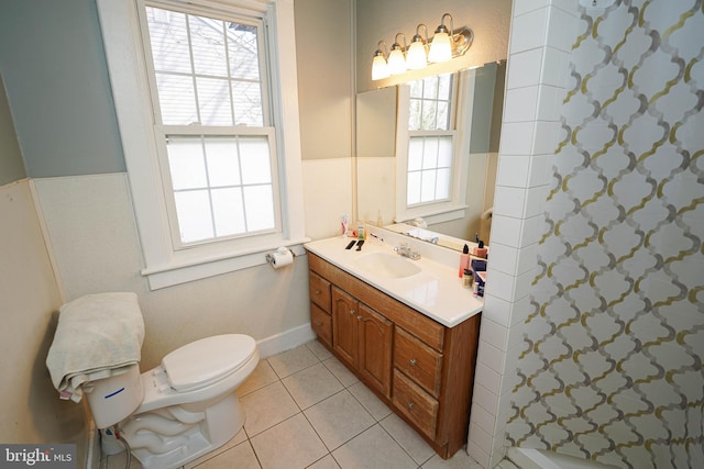 full bathroom with toilet, vanity, a shower, and tile patterned floors