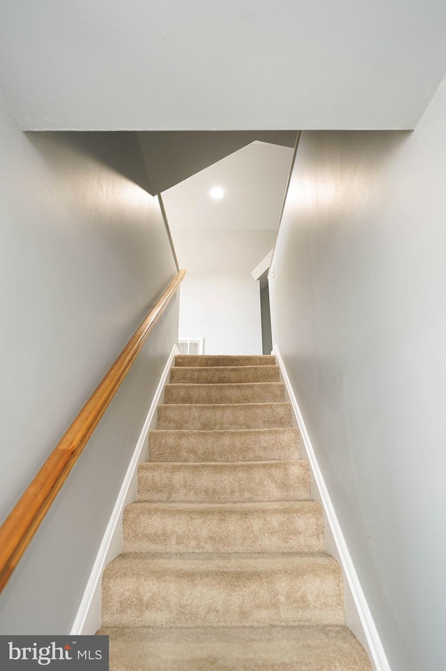 stairway with baseboards, visible vents, and recessed lighting