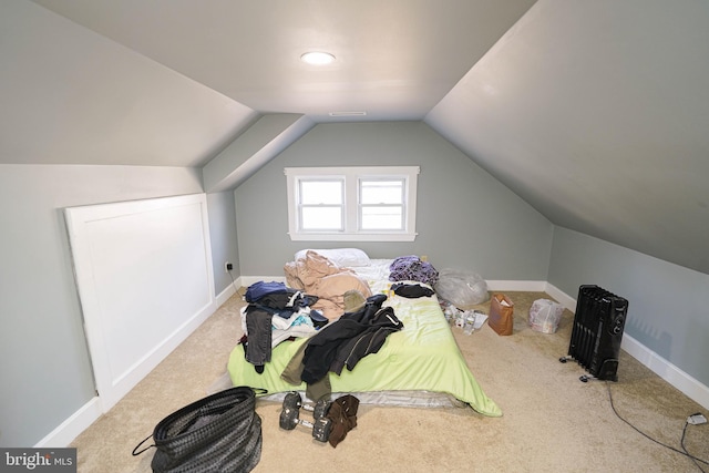 bedroom featuring carpet floors, vaulted ceiling, and baseboards