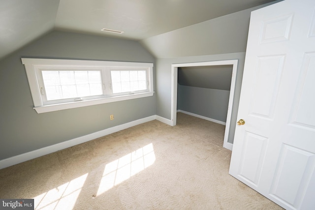 bonus room with vaulted ceiling, carpet, visible vents, and baseboards