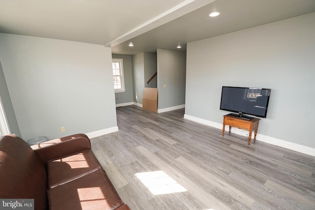 unfurnished living room featuring baseboards, wood finished floors, and recessed lighting