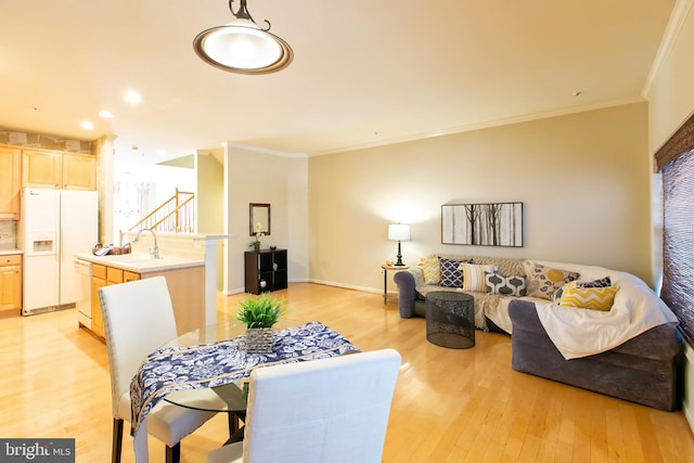 10202 Sherman Heights Pl Unit 48, Columbia, MD 21044 - dining area featuring crown molding, light wood-style floors, stairs, and baseboards