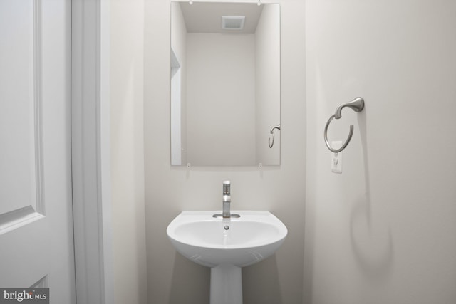 bathroom featuring visible vents and a sink