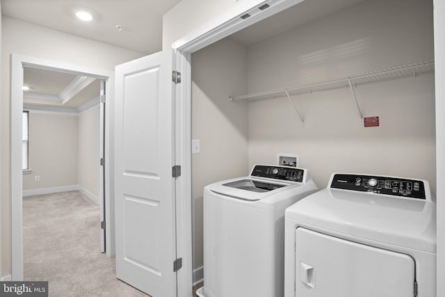 washroom with light carpet, laundry area, baseboards, washer and clothes dryer, and ornamental molding