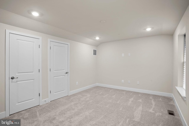 below grade area featuring baseboards, carpet flooring, visible vents, and recessed lighting