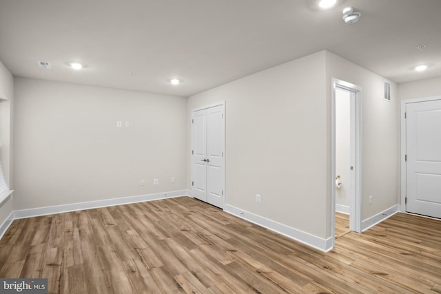 interior space with light wood finished floors, baseboards, and visible vents