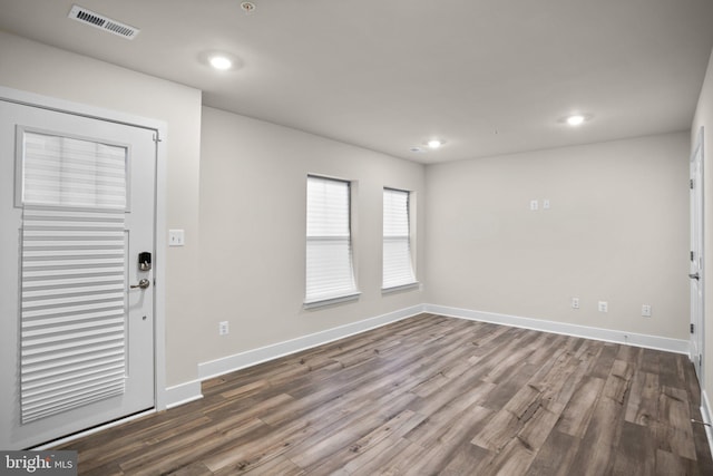 entrance foyer with dark wood-style floors, baseboards, visible vents, and recessed lighting