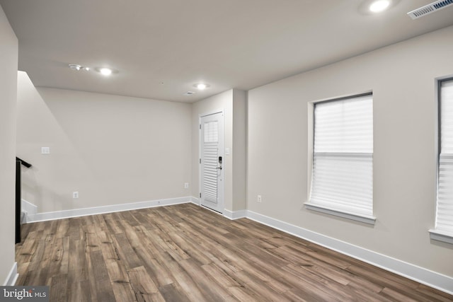 unfurnished room featuring recessed lighting, visible vents, baseboards, and wood finished floors