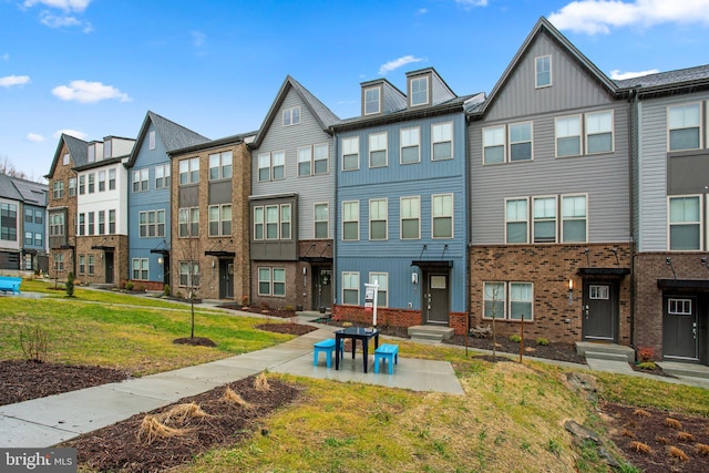 rear view of property with a residential view and brick siding