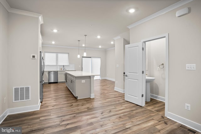 kitchen featuring light wood-style flooring, visible vents, light countertops, and stainless steel dishwasher