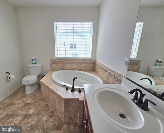 full bathroom with a garden tub, vanity, and toilet