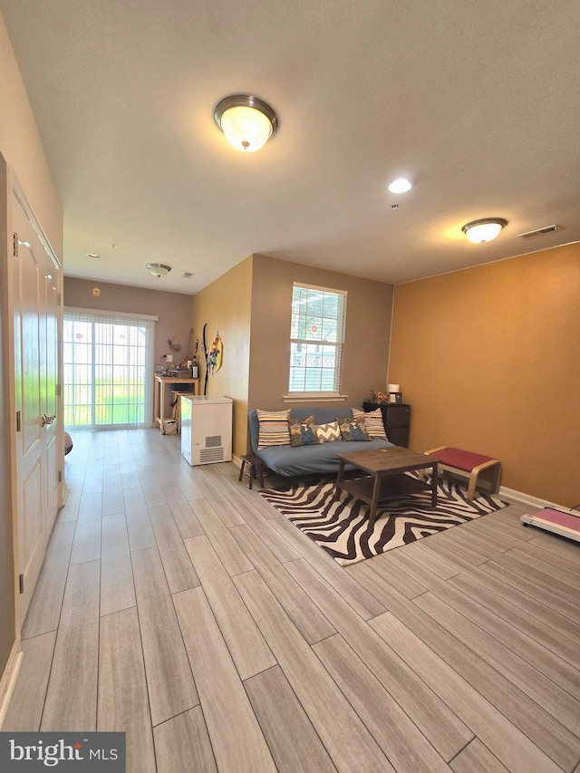 interior space with light wood-style flooring, visible vents, and baseboards