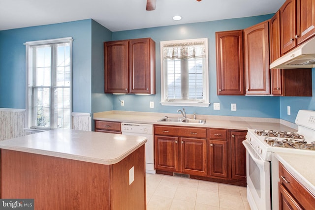 kitchen featuring light countertops, a sink, ceiling fan, white appliances, and under cabinet range hood