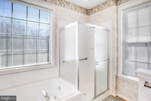 bathroom with a garden tub and a shower stall