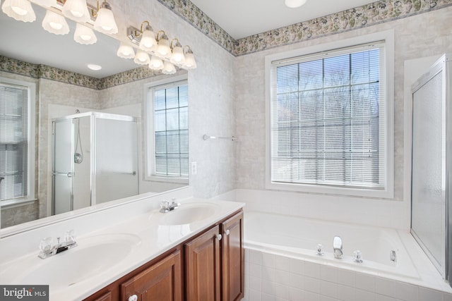 full bath featuring a healthy amount of sunlight, a stall shower, and a sink