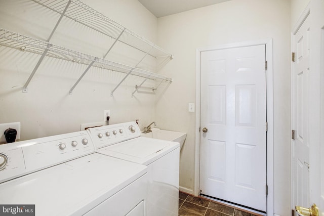 laundry area with laundry area, a sink, and washer and clothes dryer