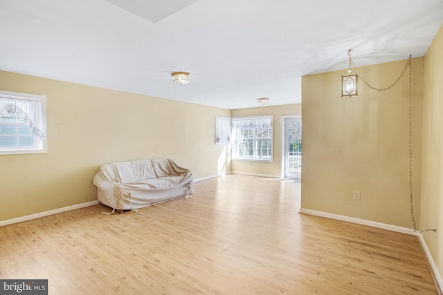 unfurnished room featuring baseboards and wood finished floors