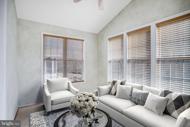 tiled living room with lofted ceiling and a ceiling fan