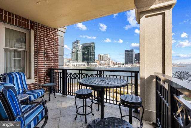 balcony with a water view and a city view