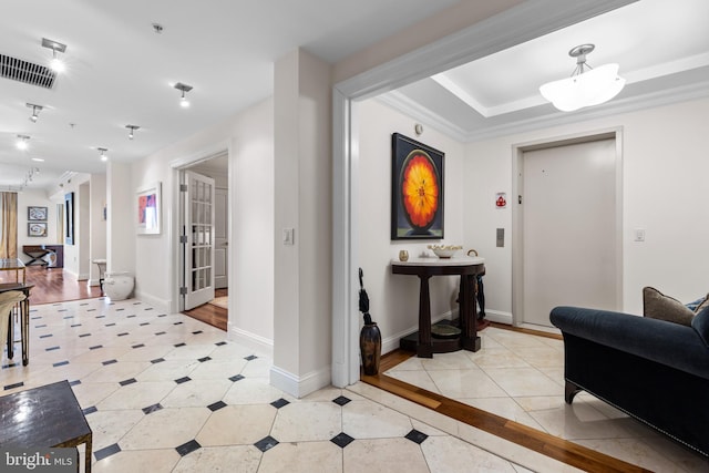 interior space with visible vents, crown molding, baseboards, and light tile patterned flooring