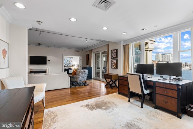 home office with a fireplace, recessed lighting, visible vents, track lighting, and light wood-type flooring