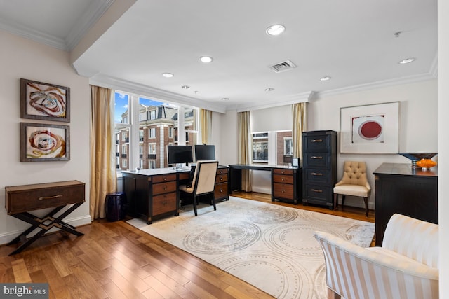 office space featuring visible vents, baseboards, ornamental molding, light wood-style floors, and recessed lighting