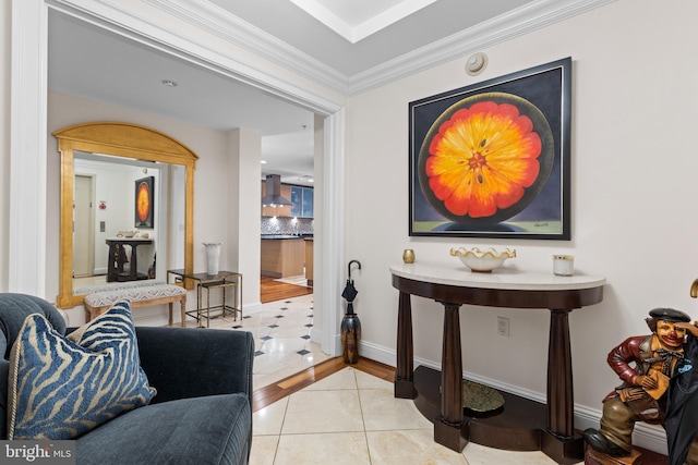 hallway with baseboards, crown molding, and tile patterned floors