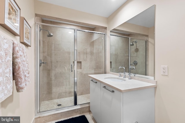 bathroom featuring a stall shower and vanity