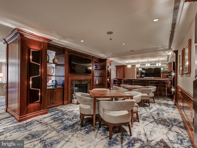 dining room with recessed lighting and a fireplace