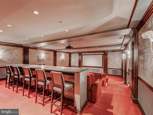 home theater room with wallpapered walls, wainscoting, wet bar, a decorative wall, and recessed lighting