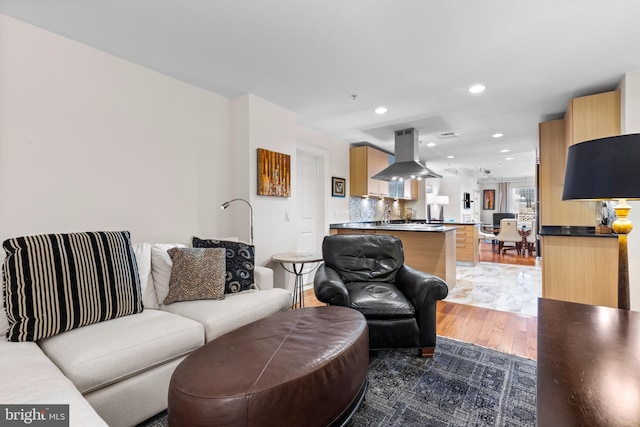 living area featuring dark wood-type flooring and recessed lighting