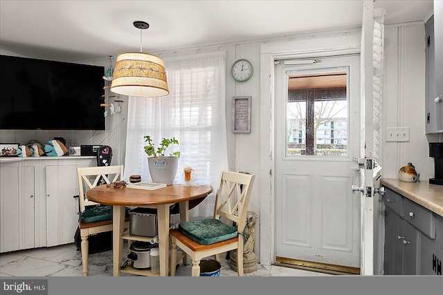 dining space with marble finish floor