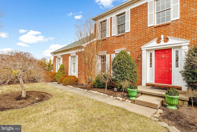 doorway to property featuring brick siding