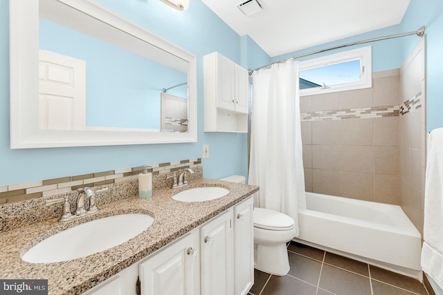 bathroom featuring a sink, visible vents, toilet, and tile patterned flooring