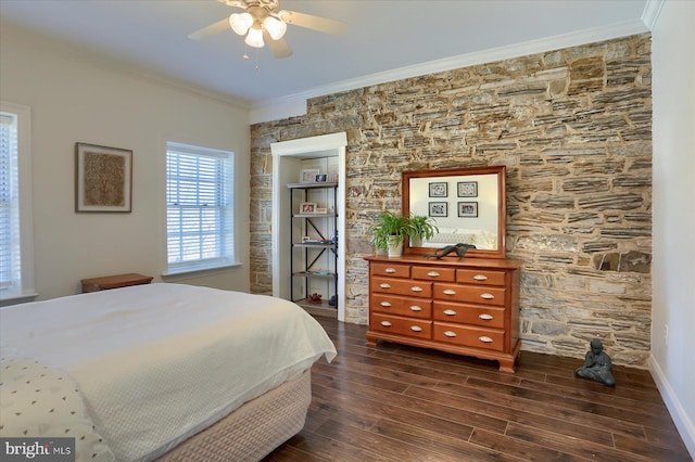 bedroom featuring dark wood-type flooring, crown molding, baseboards, and ceiling fan