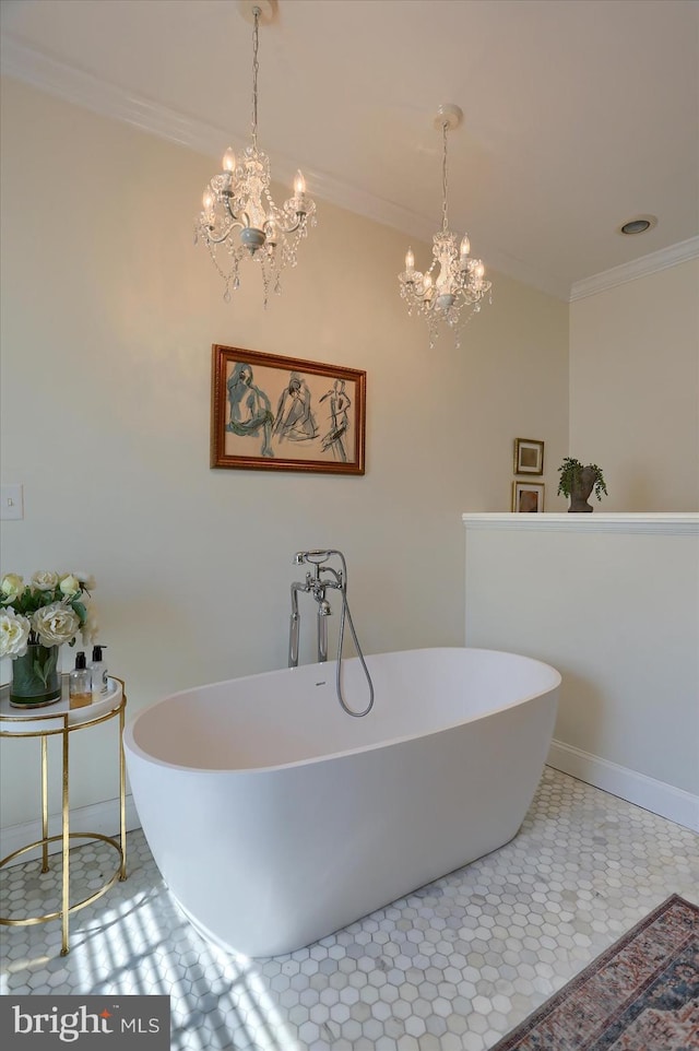 full bath featuring a freestanding tub, crown molding, and an inviting chandelier